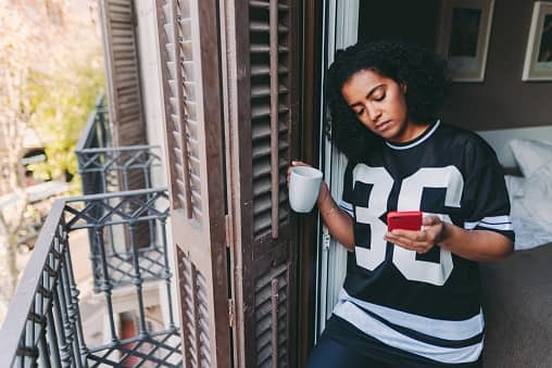 woman looking at phone on terrace